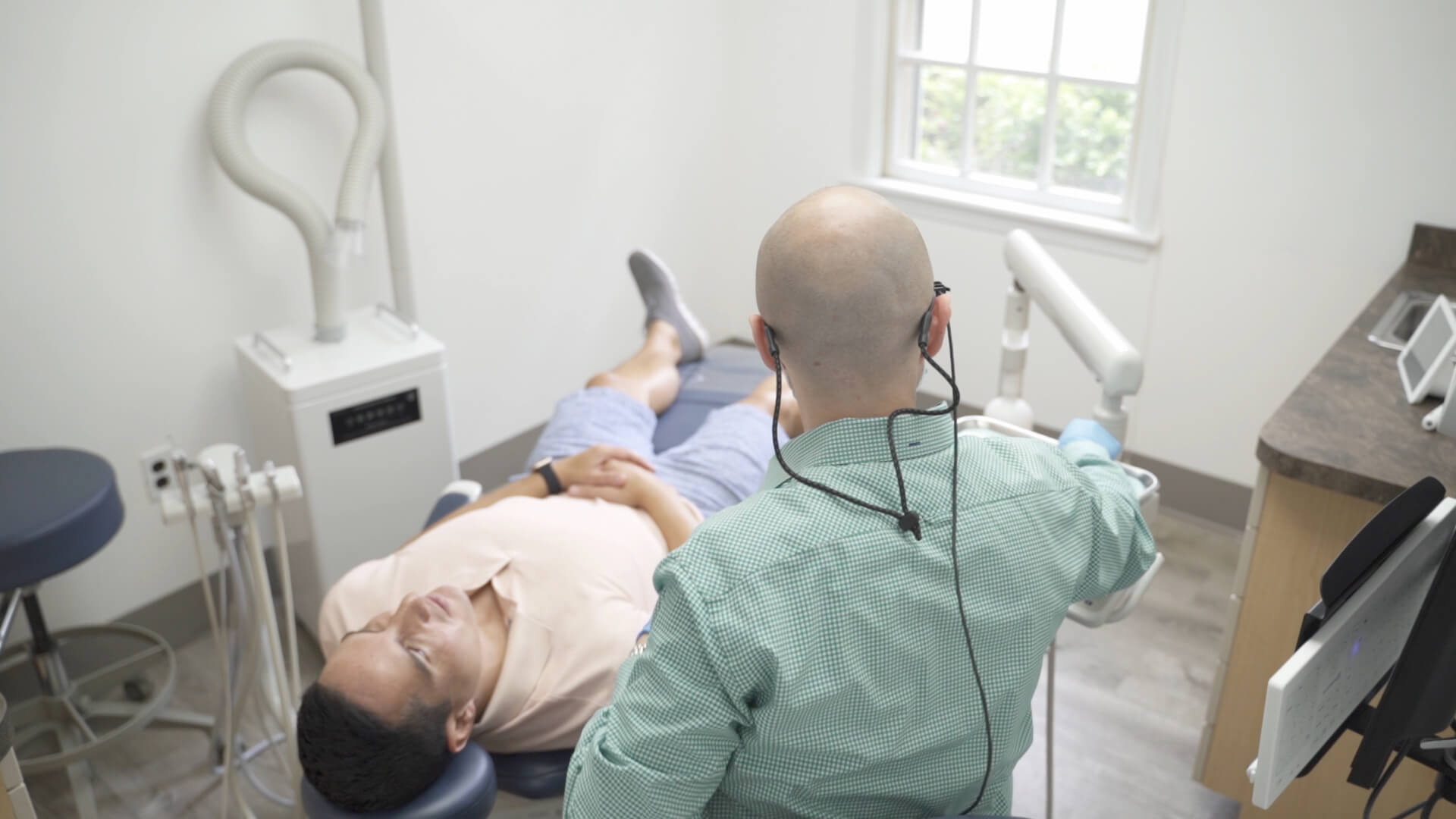 Dr. Dahman meets with reclining patient