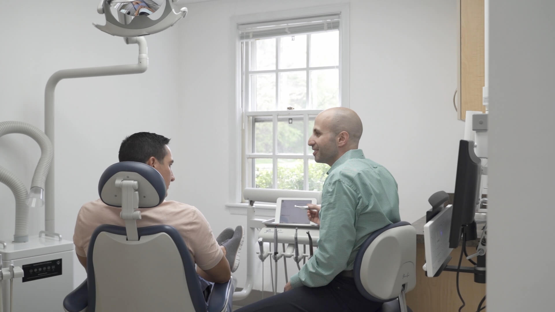 Dr. Dahman with a patient in a dentist chair