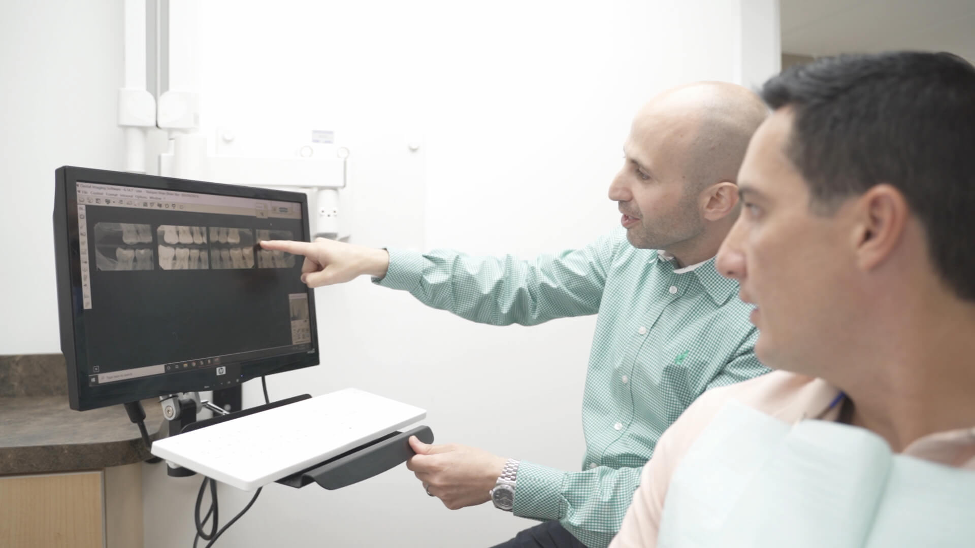 Dr. Dahman discussing an X-ray with a patient