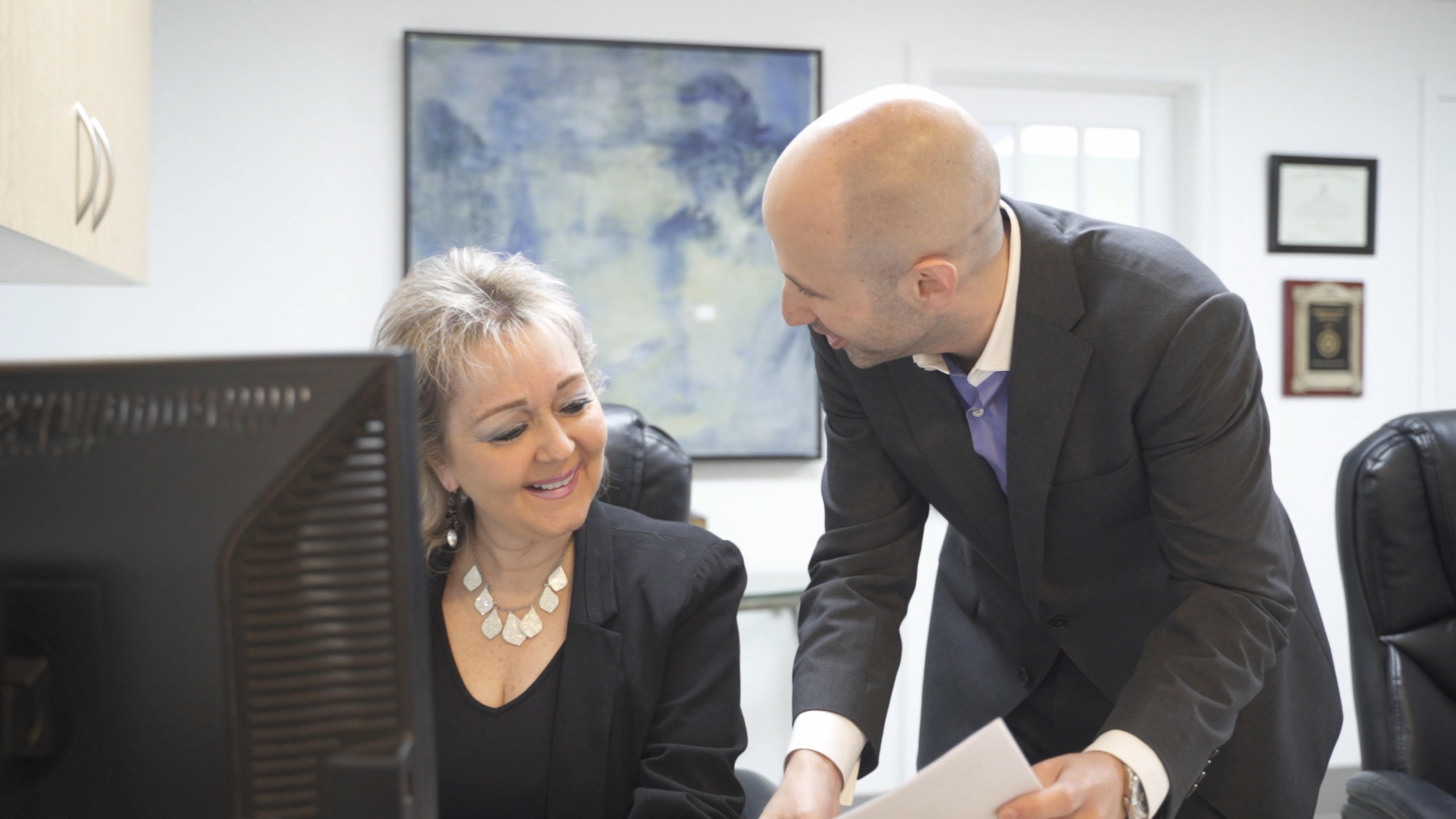 Dr. Dahman and Liz reviewing files.