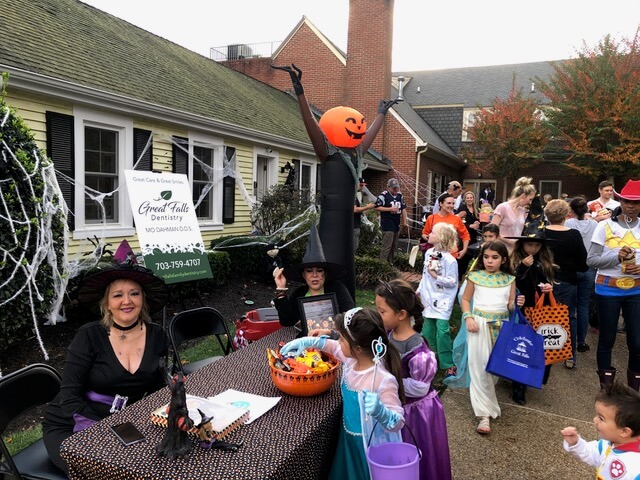 Children in costume grab some halloween candy from our table