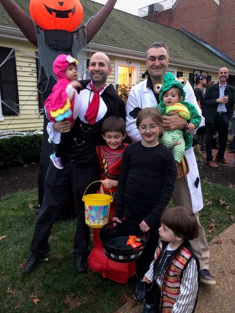 Dr. Dahman in a vampire costume with kids in costume