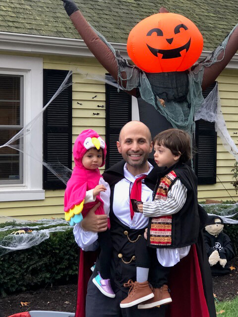 Dr. Dahman and children with a jack-o-lantern man