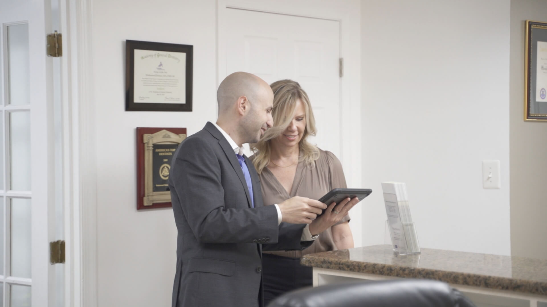 Dr. Dahman and Julie checking a tablet