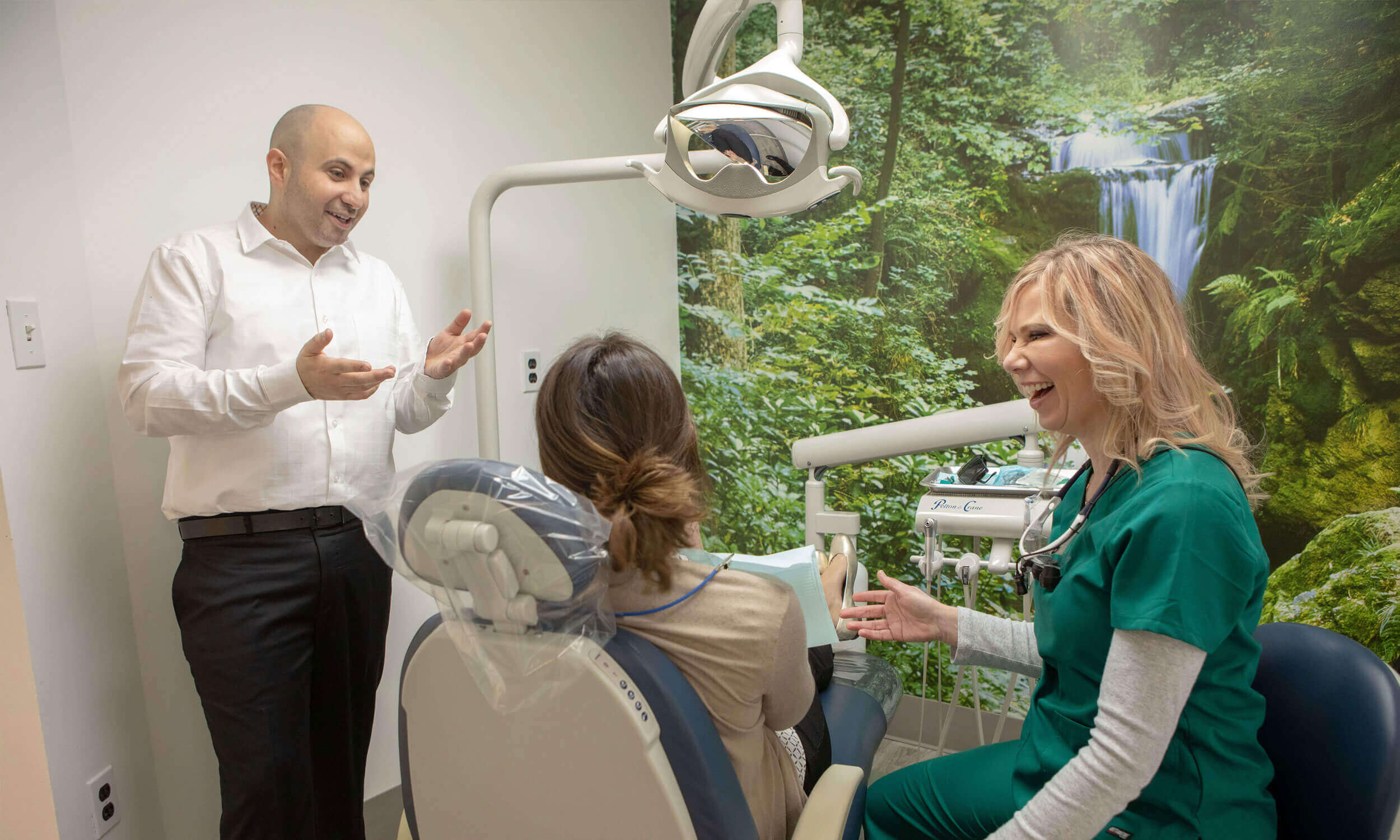 Dr. Dahman and assistant laughing with a patient