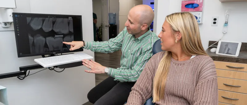 Dr. Dahman showing a patient about teeth