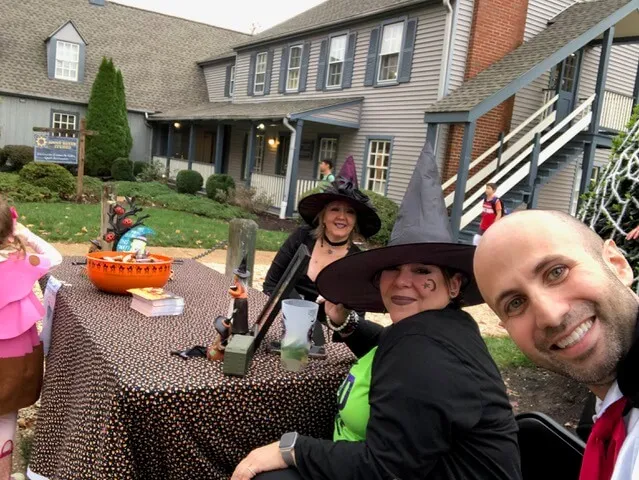 Dr. Dahman in a vampire costume with two team members in witch costumes