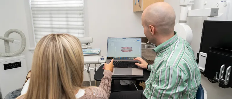 Dr. Dahman and client showing teeth