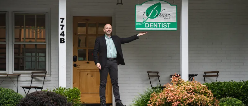 Dr. Dahman standing outside with sign