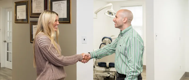 Dr. Dahman shaking hands with a patient